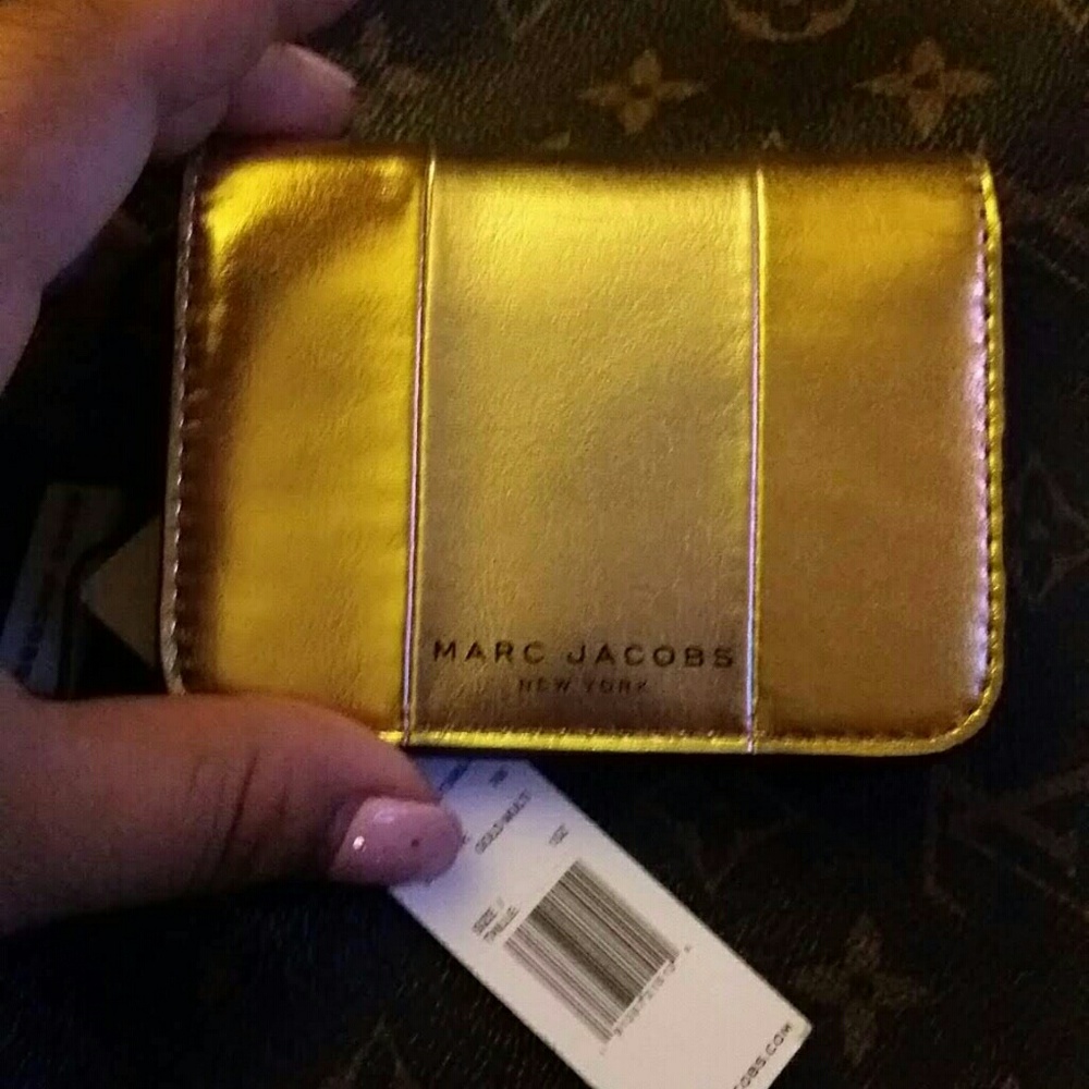 Marc Jacobs gold leather single fold wallet.